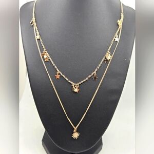 Delicate gold star doble strand necklace featuring a 1.3cm star pendant